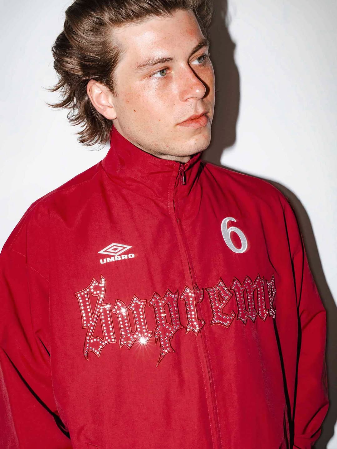 Supreme x Umbro Rhinestone Track Jacket in white nylon shell with rhinestone embellishment along seam lines