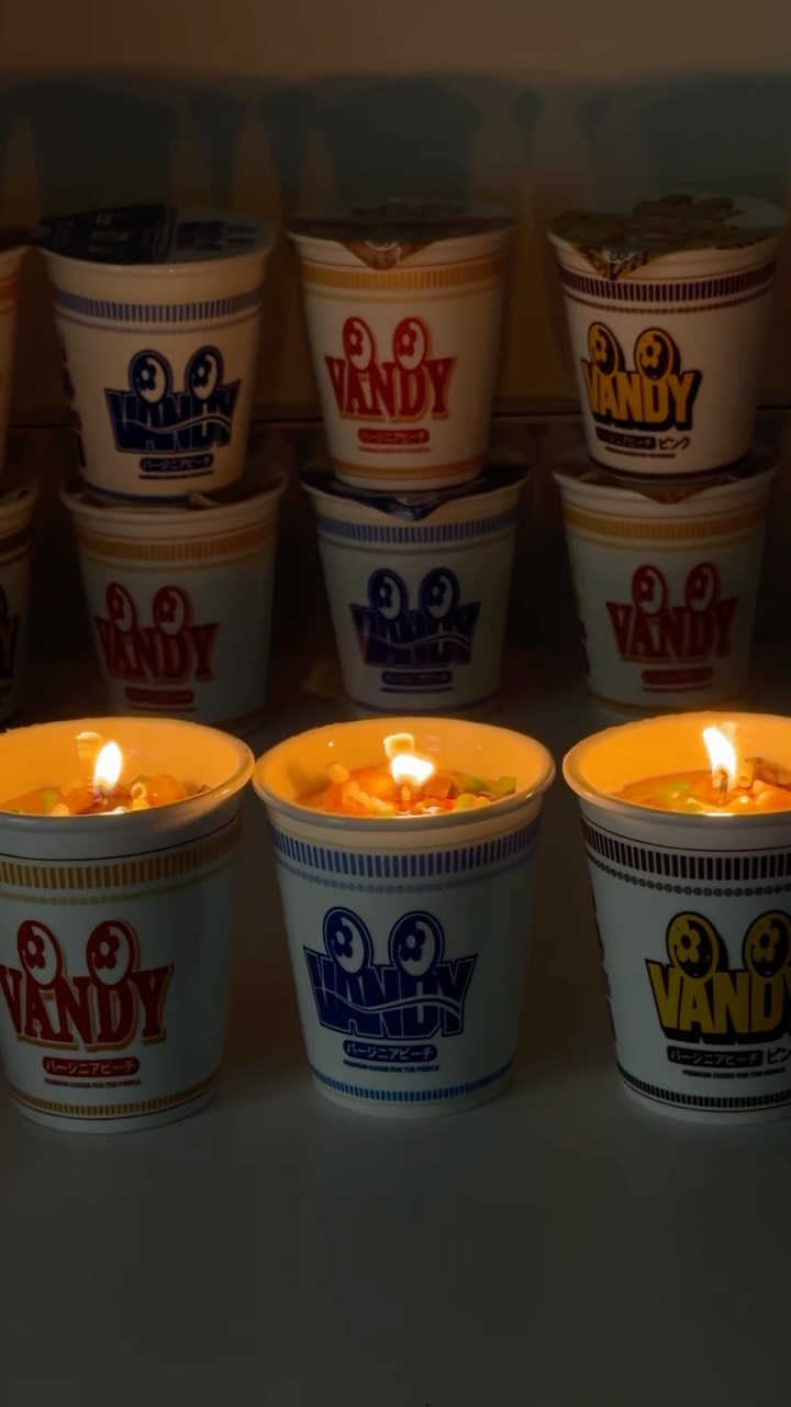 The Vandy The Pink Cup Noodle Candle, styled to resemble a cup of instant ramen noodles.