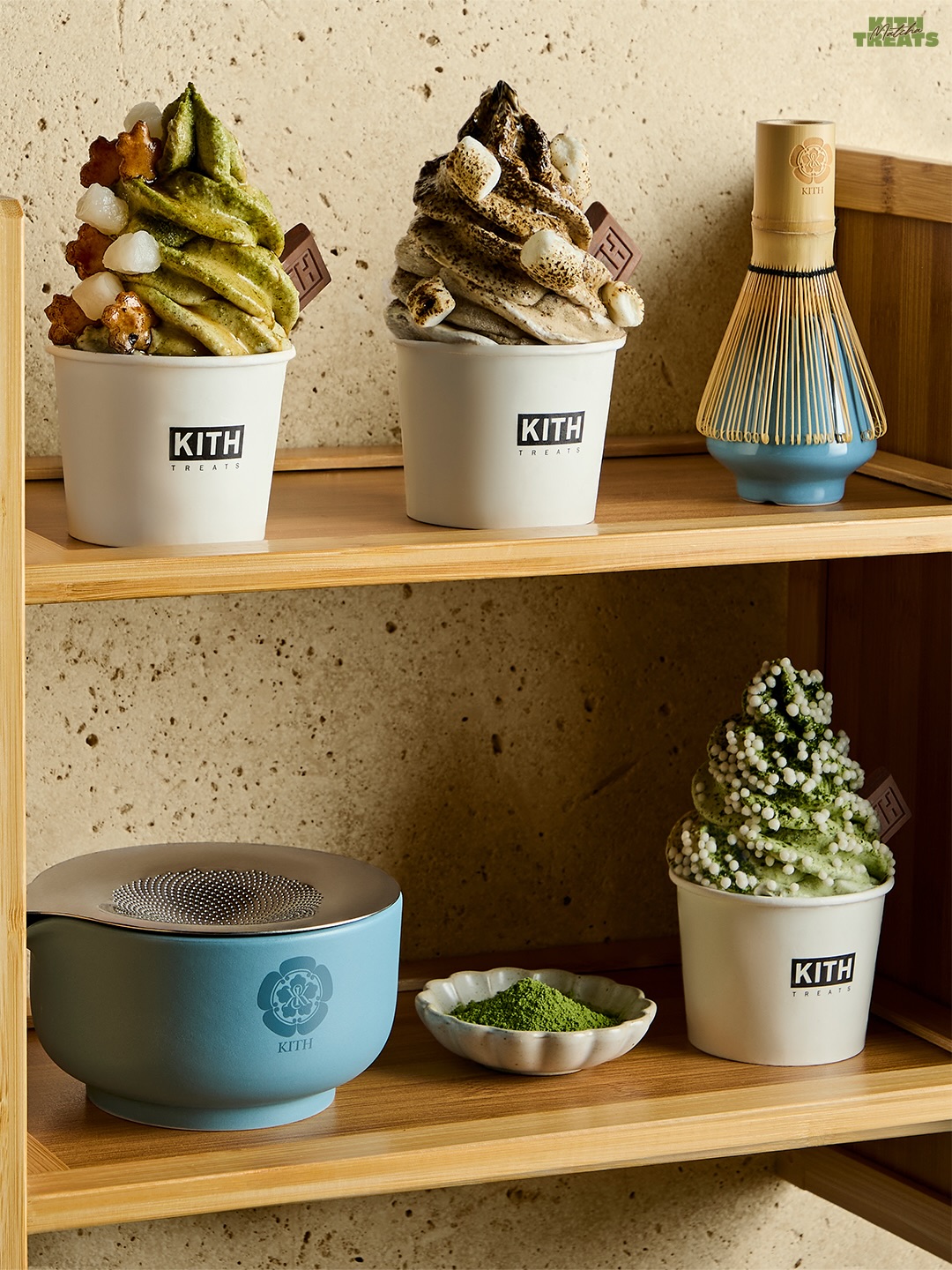 Three scoops of swirled ice cream, matcha green, genmaicha beige, and hojicha brown, topped with mochi and roasted marshmallow in a Kith Treats cup.