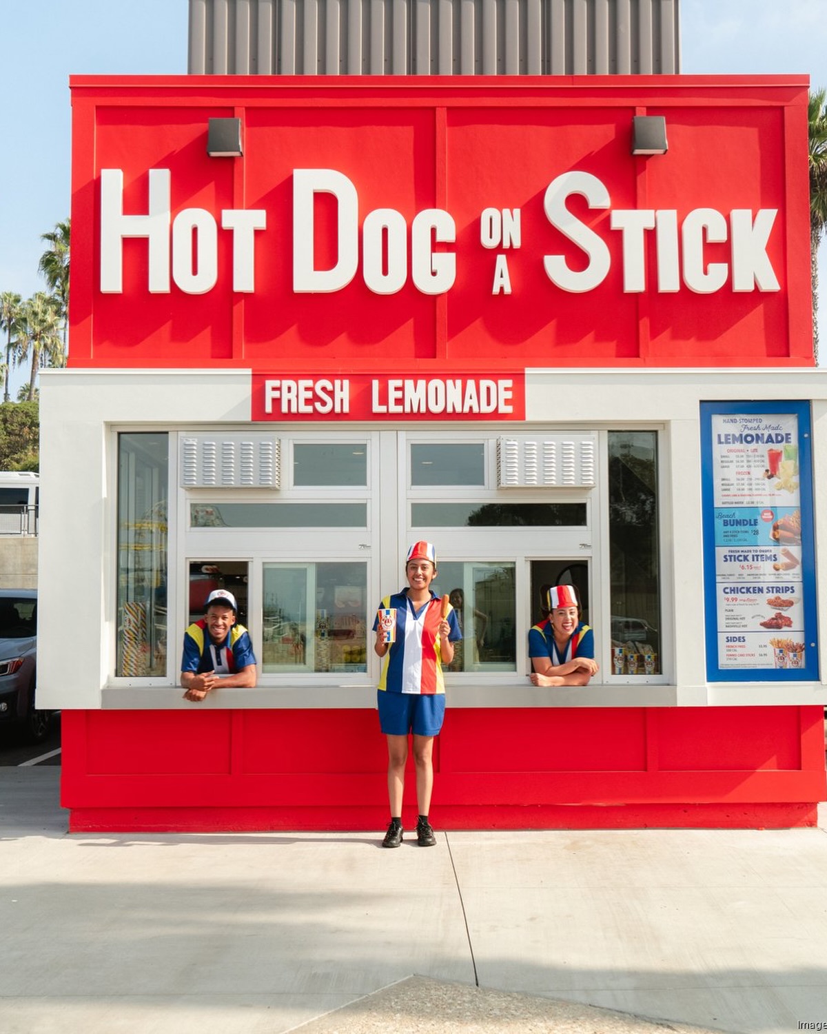 Hot Dog on a Stick branded graphic announcing its acquisition by Amazing Brands