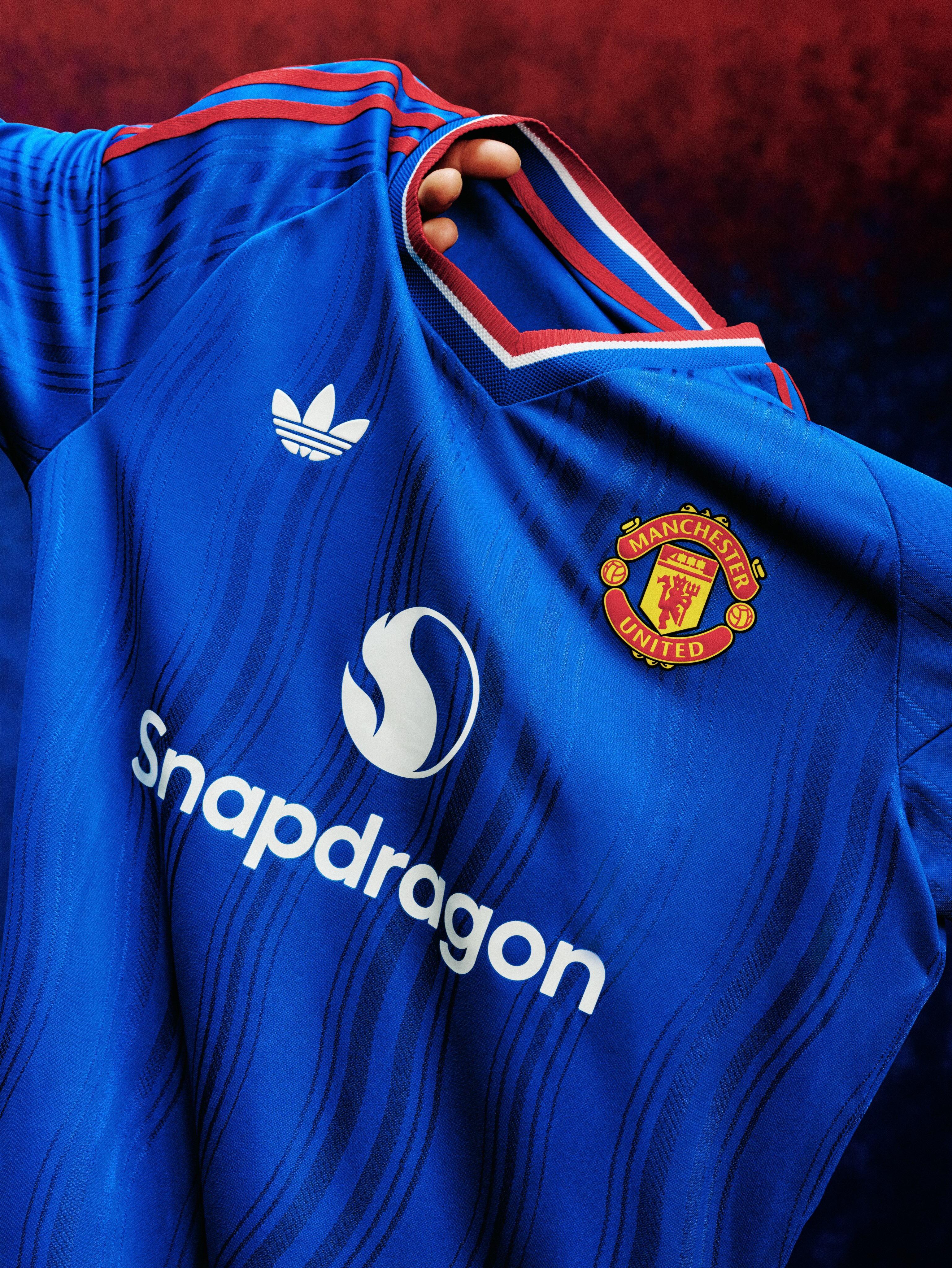 Manchester United's royal blue 2026/27 adidas away jersey with red and white trim