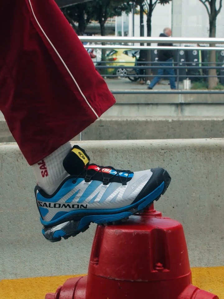 Salomon XT-4 Race Flag Capsule trail sneaker showing the woven tricolor tongue label