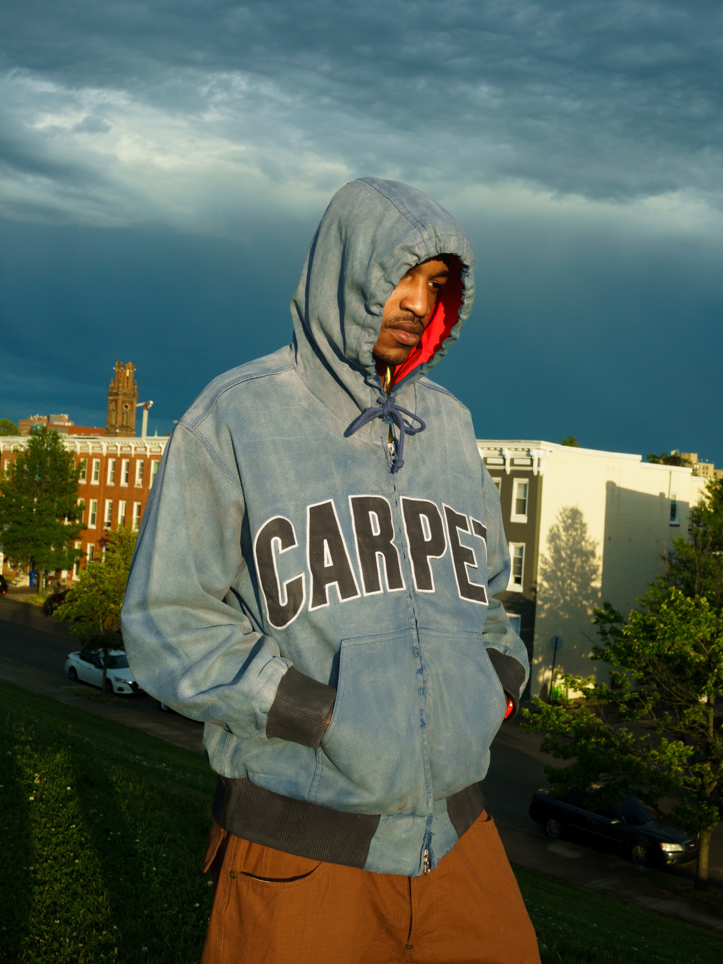 Carpet Company Season 22 Drop 2 apparel including a waxed appliqué work jacket and ringer varsity tee