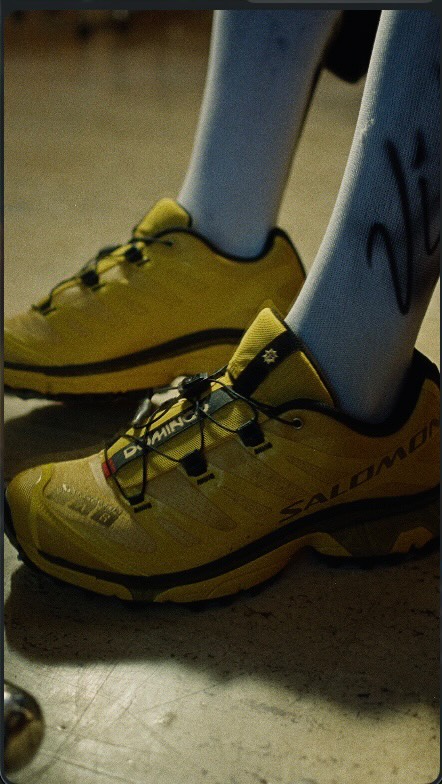 The Salomon x Undefeated Domingo XT-4 OG sneaker in a lemon and gold colorway.