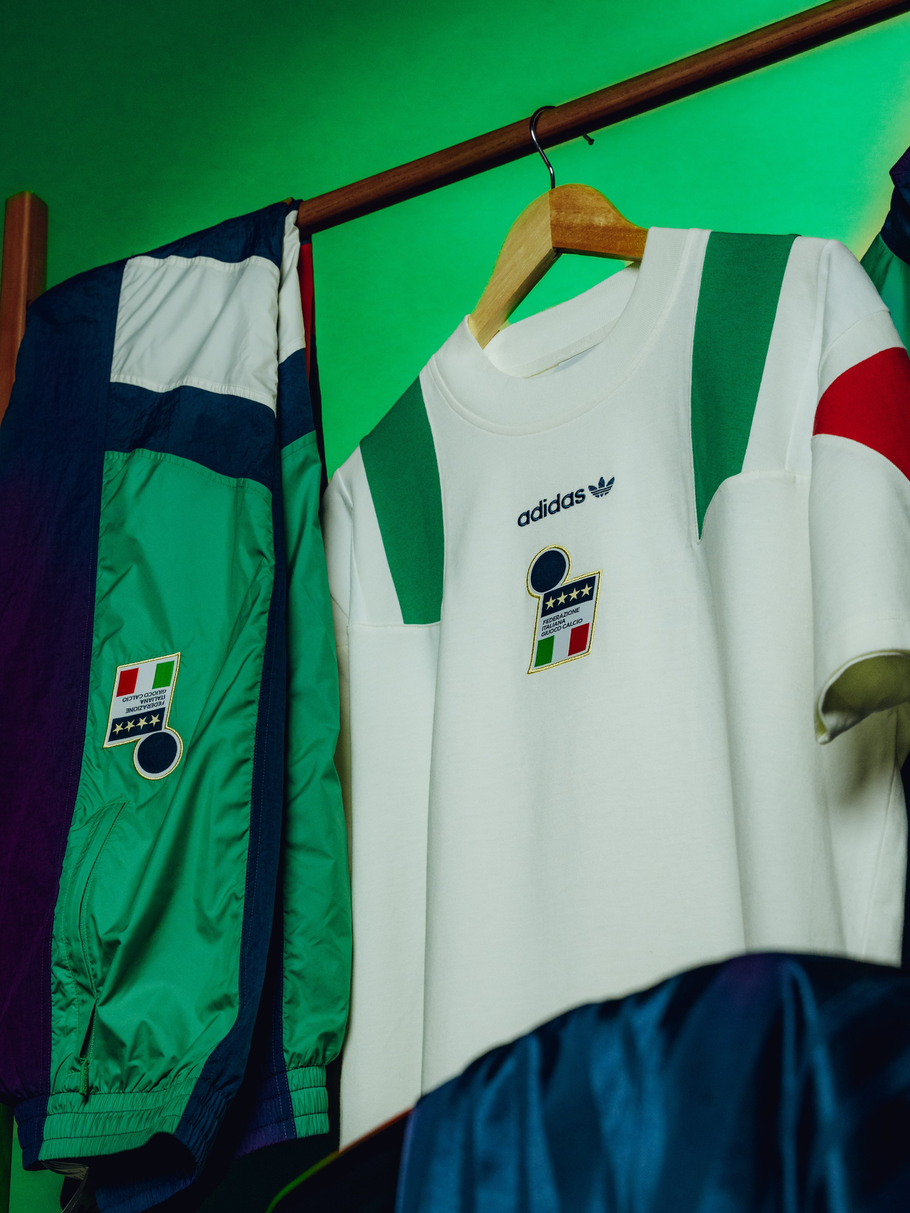 Green, navy, white and red Adidas Italy EQT jacket on a wooden hanger with a four star FIGC crest.