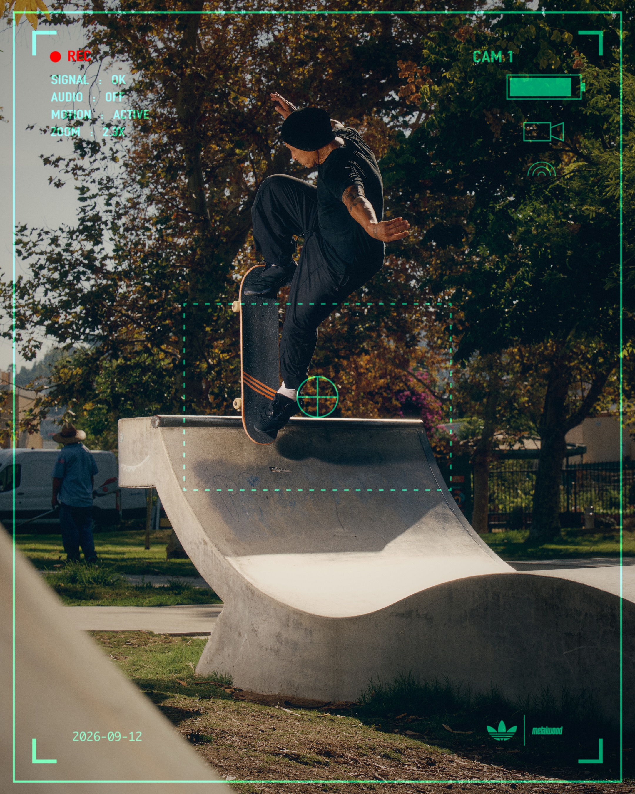 Skater wearing black Adidas and Metalwood Predator Sala shoes above a curved concrete obstacle within a green camera graphic.