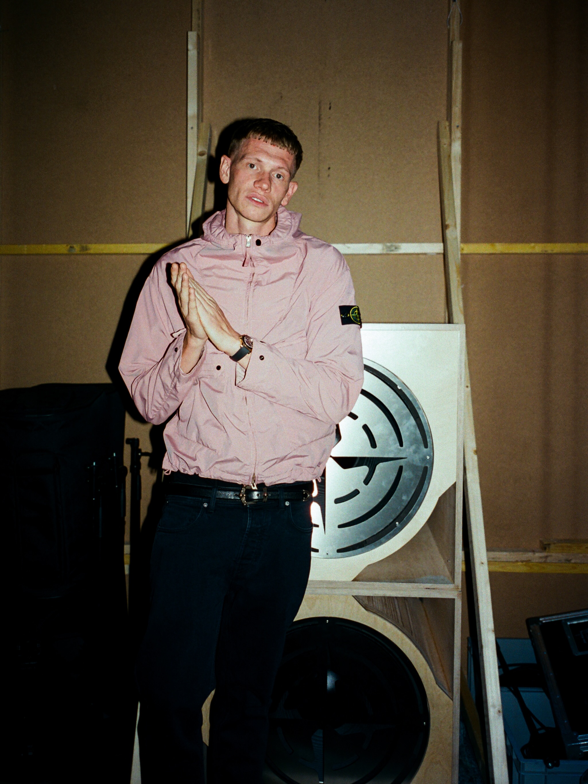 A performer in white holds a microphone within the Studio One London crowd.