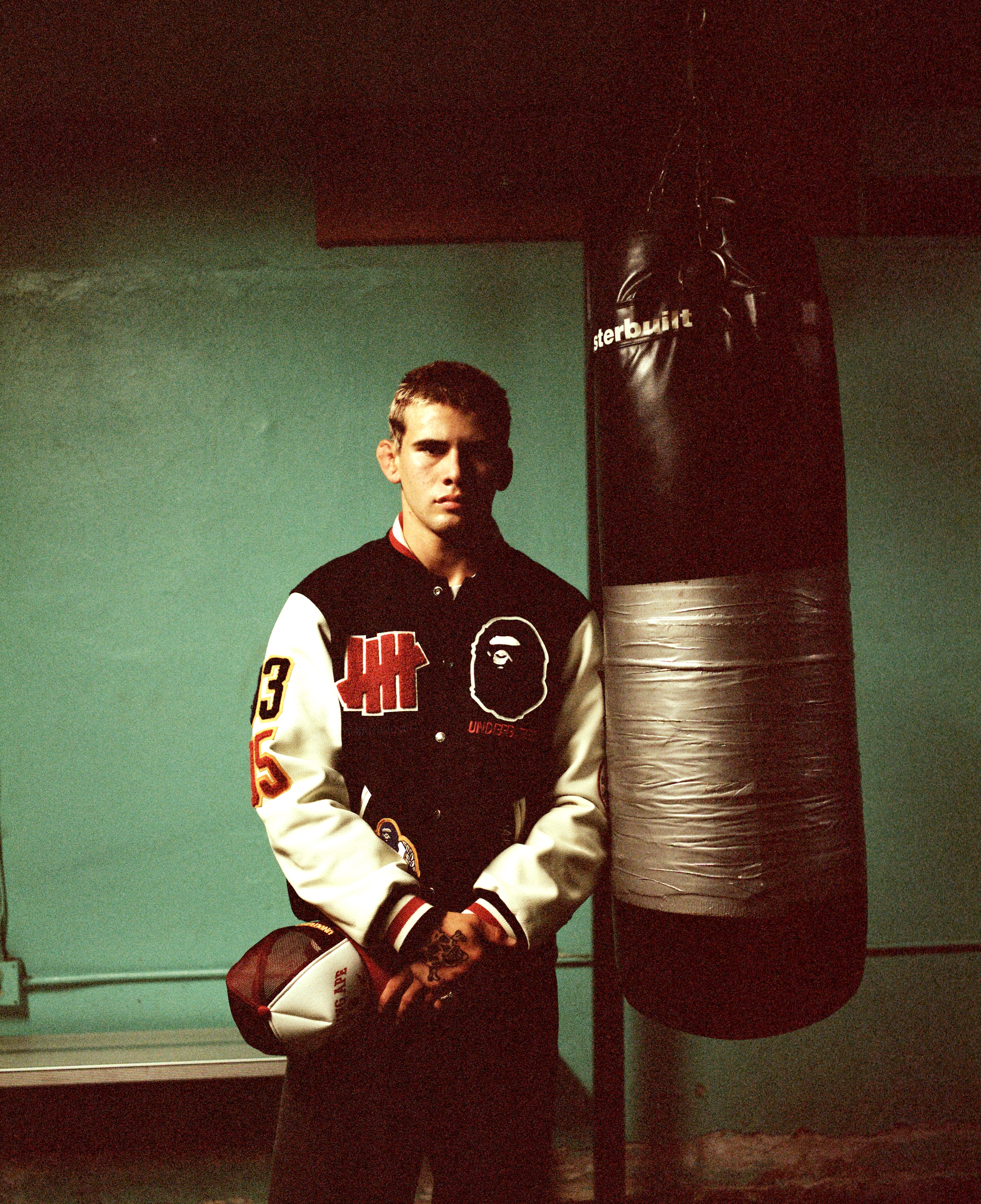 Cover image from UNDEFEATED's announcement of its BAPE varsity jacket and mesh cap