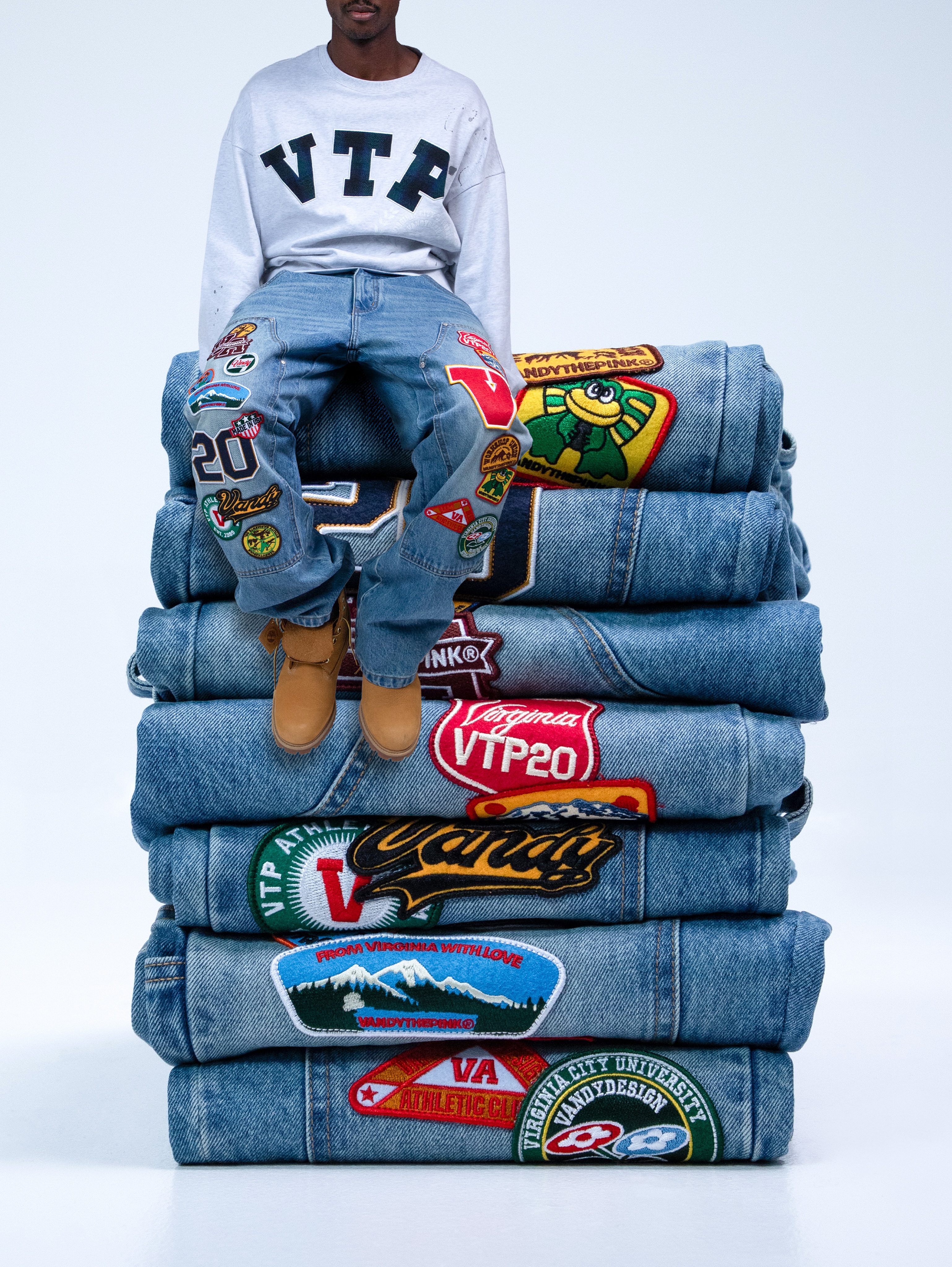 Vandy The Pink Patchwork Double Knee Denim in a vintage inspired wash with varsity patches, graphics and embroidered details