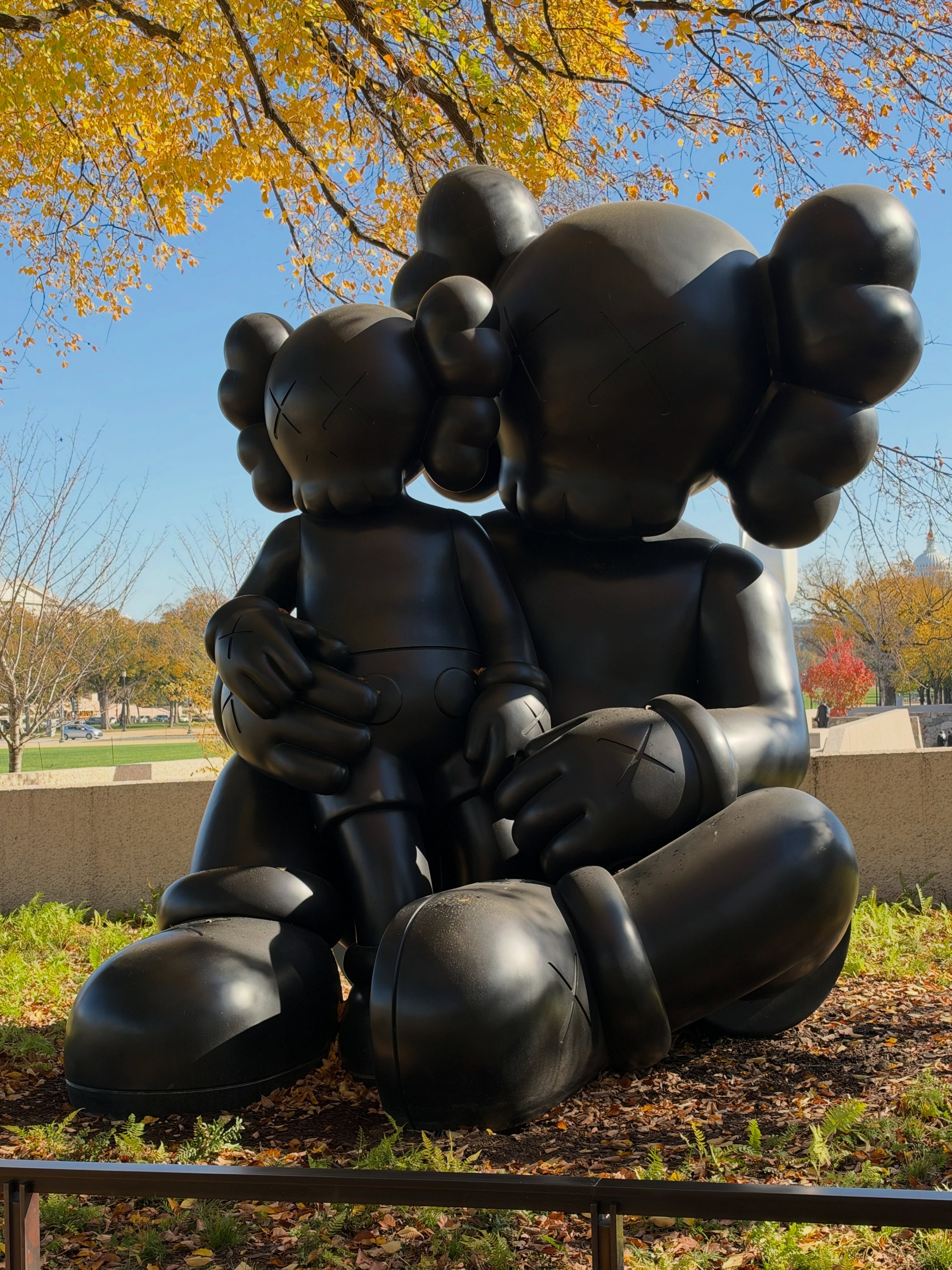 KAWS SHELTER, a bronze sculpture of two COMPANION figures, at the Hirshhorn Sculpture Garden