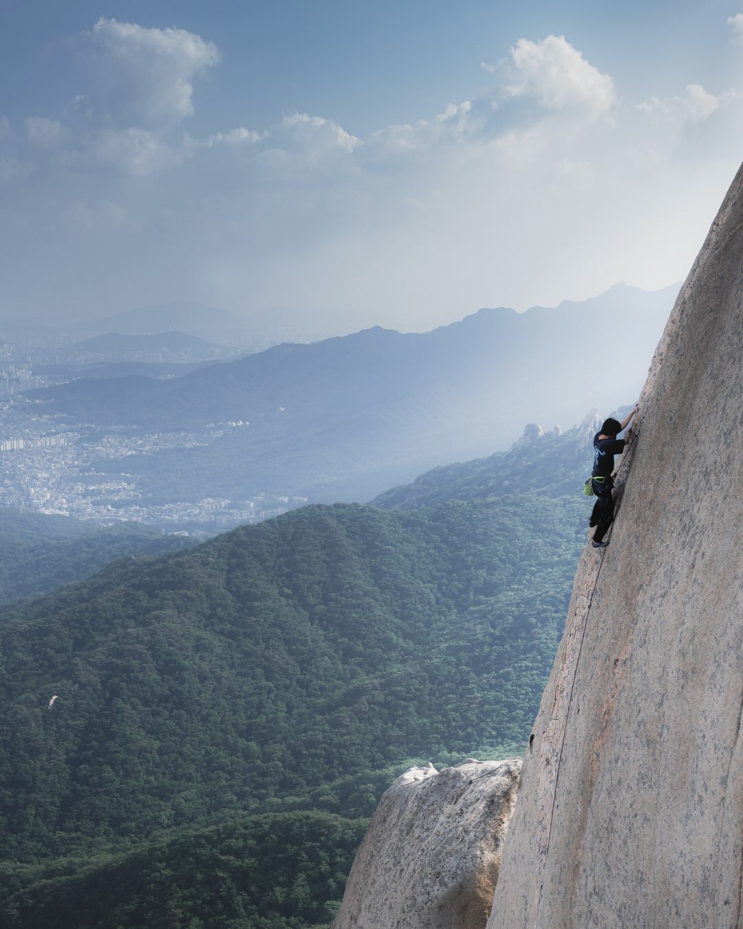Minyoung Lee climbing a granite crack route on Seoninbong peak in Dobongsan, South Korea