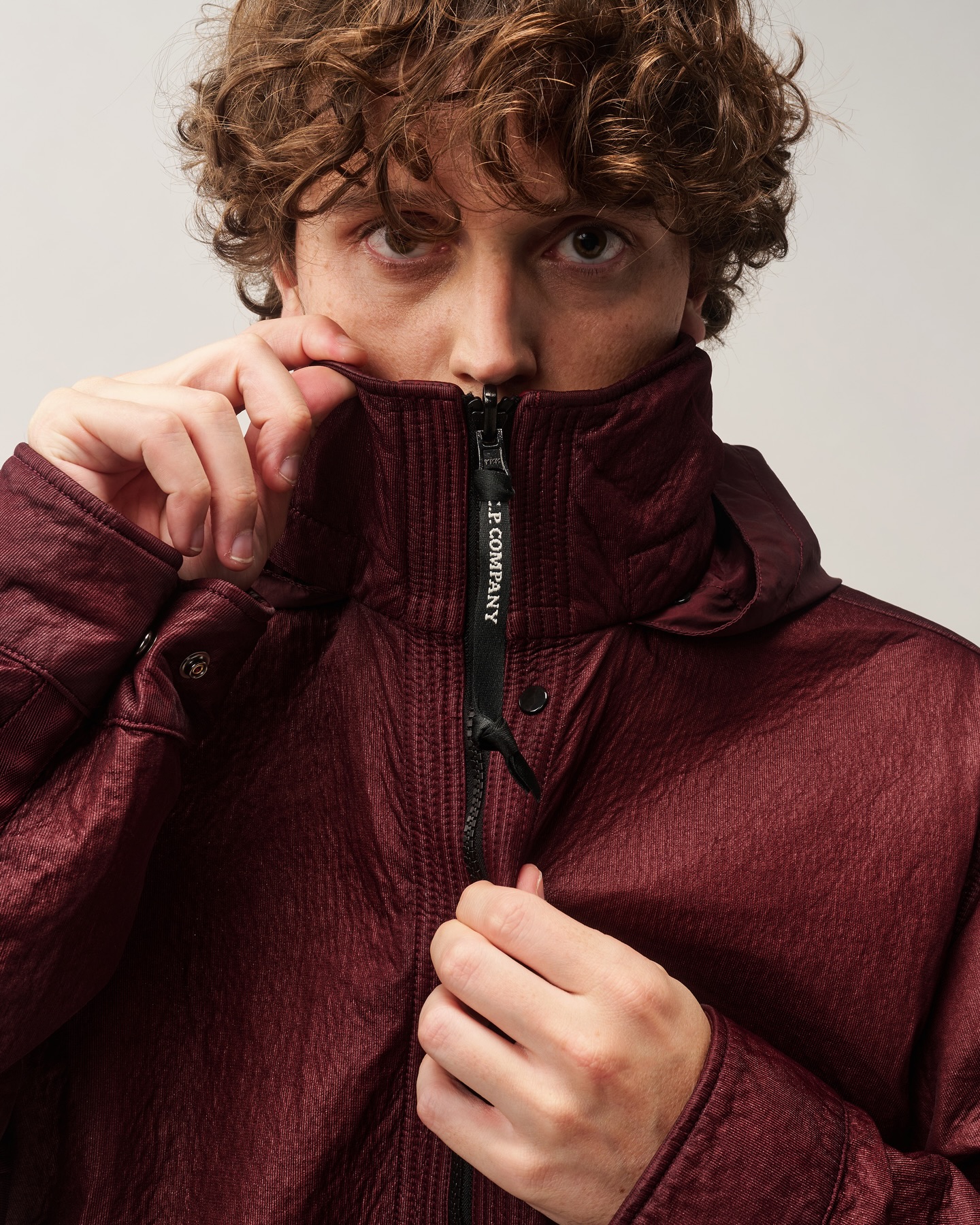 A model wearing C.P. Company's reversible Bi-Face jacket from the FW026 collection.