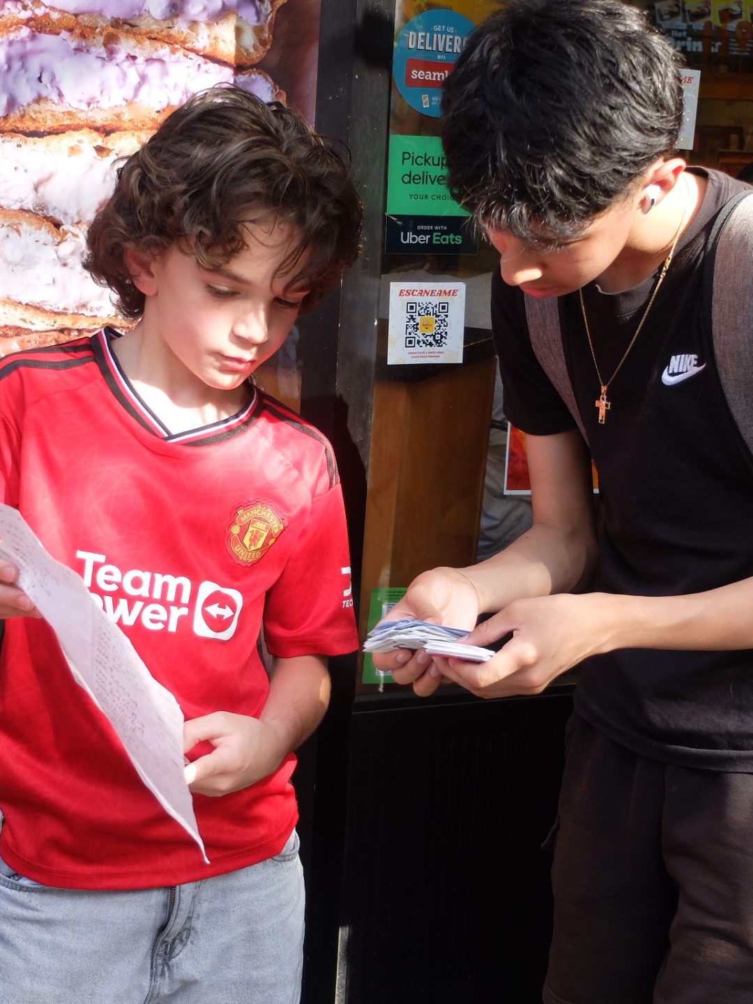 A crowd trading Panini World Cup stickers on a Jackson Heights, Queens street corner