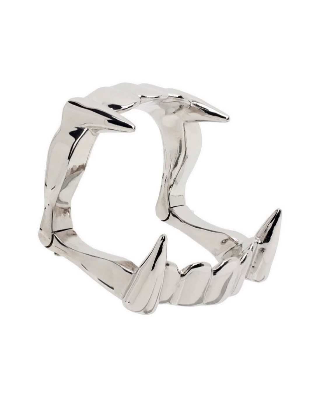 A silver toned brass cuff bracelet cast with two vampire fangs, from Raf Simons' final runway collection.