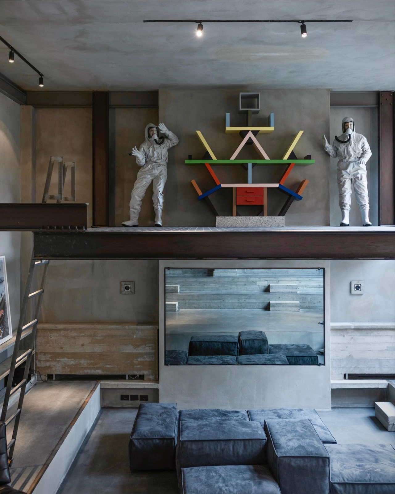 A board formed concrete interior of a Brutalist Milan home with a black metal staircase, as shown in Design Milk's Instagram post.