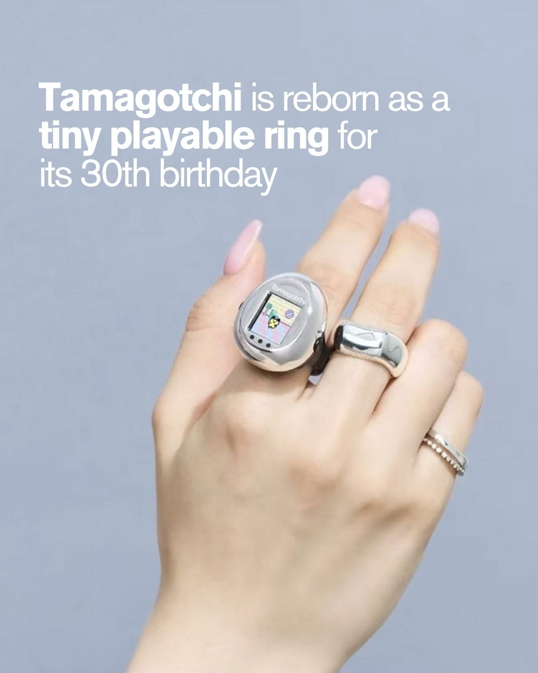 The Bandai Tamagotchi ring shown in its egg shaped wearable case as part of the 30th anniversary lineup.
