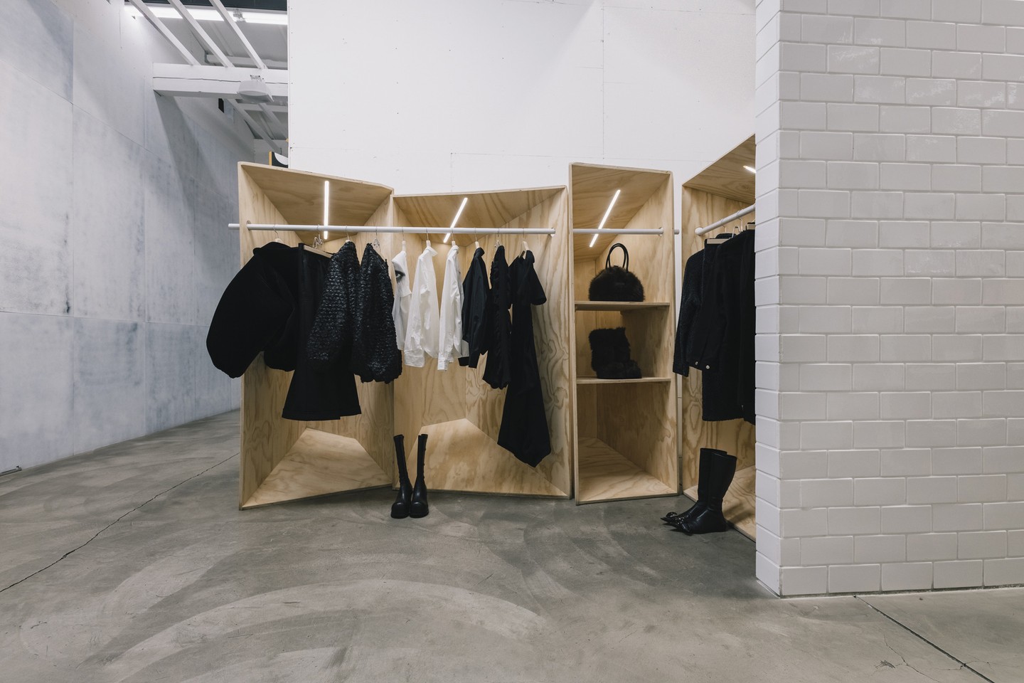 Pale wood panels and a metal rail frame Melitta Baumeister’s dark garments at DSM LA.