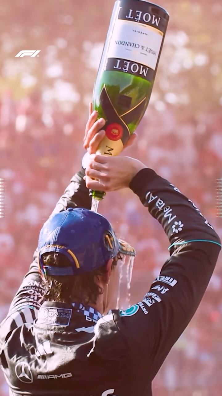 Kimi Antonelli celebrating with champagne on the Monza podium after winning the 2026 Italian Grand Prix.