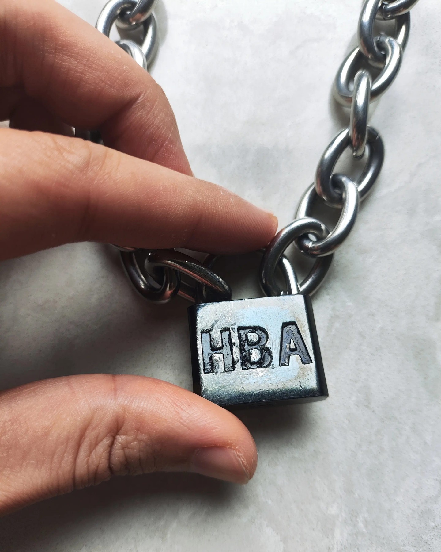 A Hood By Air Padlock Chain necklace from the brand's S/S 15 era, listed for resale on Grailed.