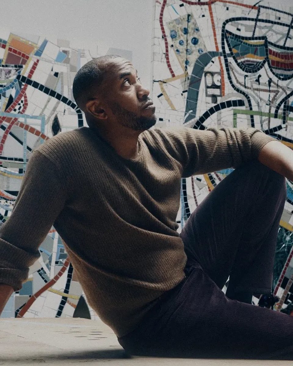 Rashid Johnson sits in front of a patterned artwork in Erik Tanner’s portrait.