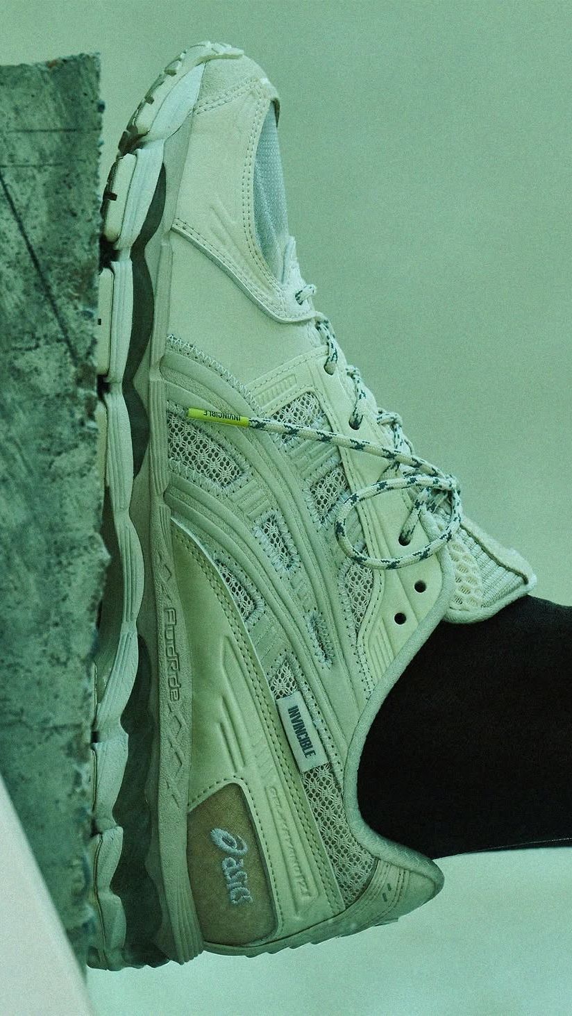 An Invincible x Madness x Asics Gel Kayano 12.1 sneaker in muted vintage cream tones with translucent mesh paneling
