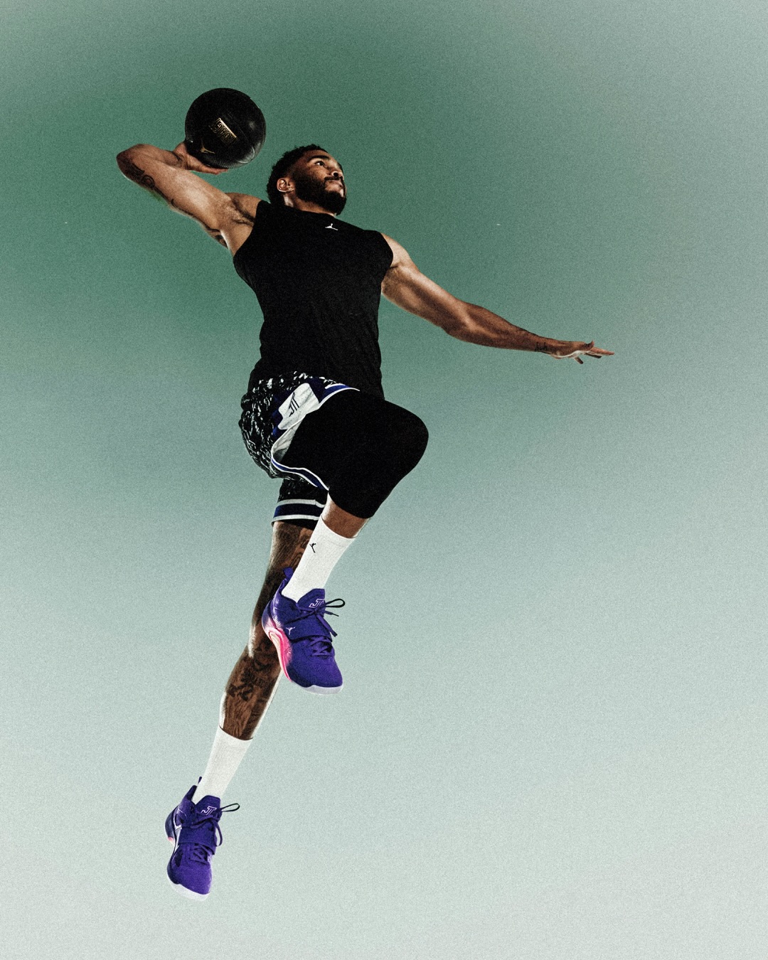 The Jordan Tatum 5 Sunrise in Bright Concord purple with pink accents.