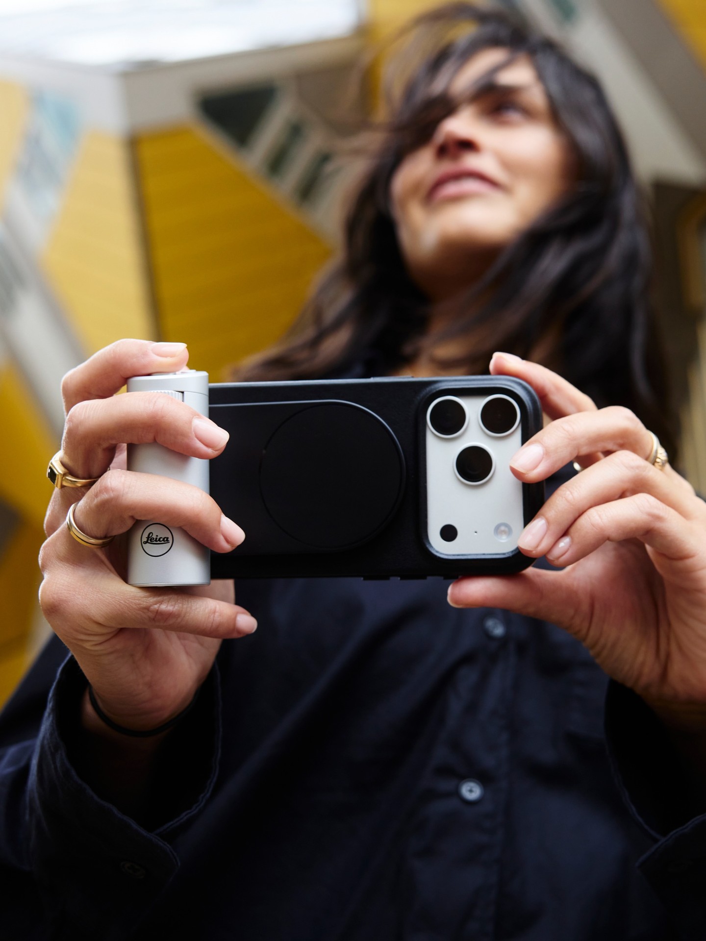 The Leica LUX Grip in classic silver attached to an iPhone