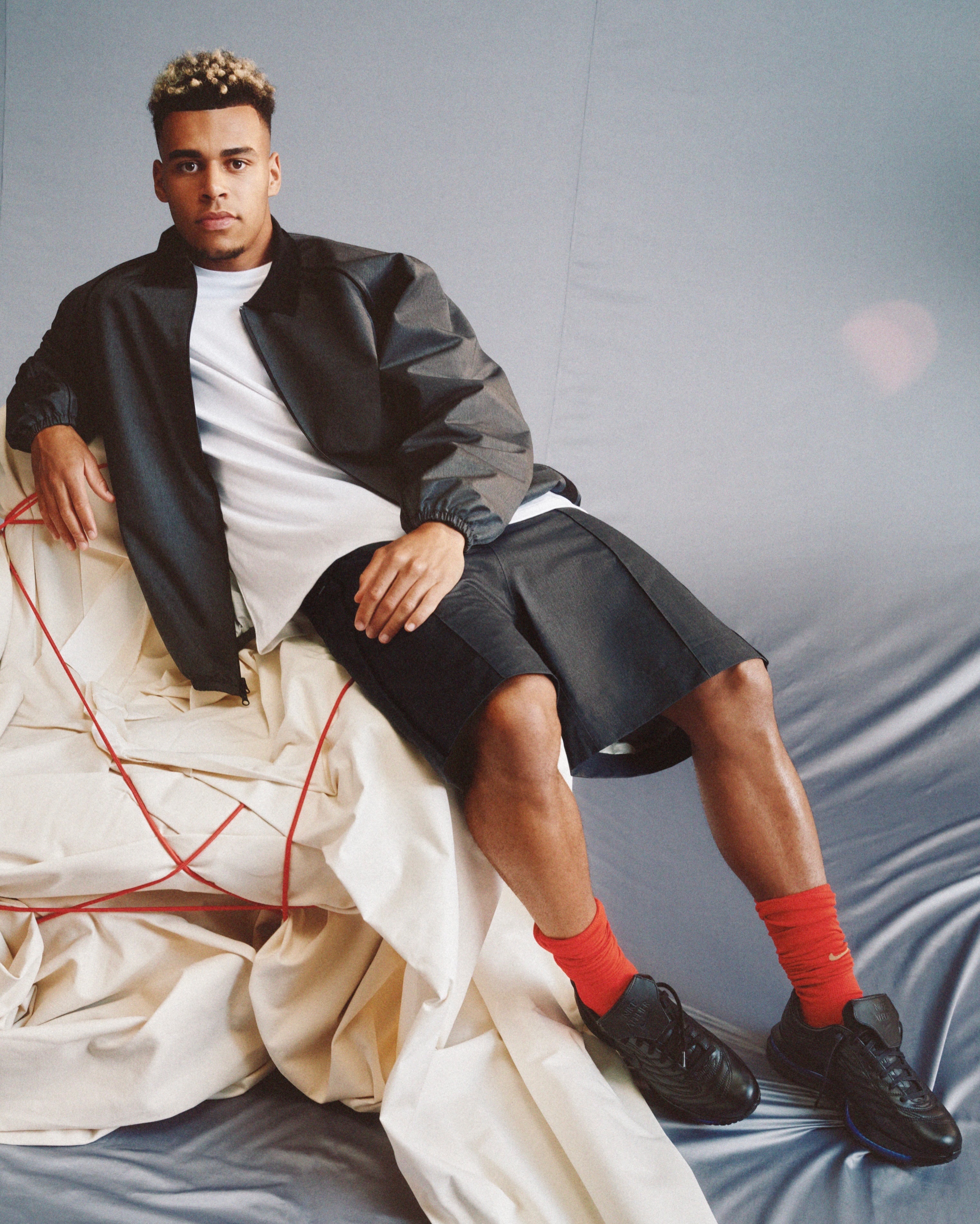 Desire Doue pictured in a Nike Football promotional image wearing the custom Nike Atelier Merc Premium.