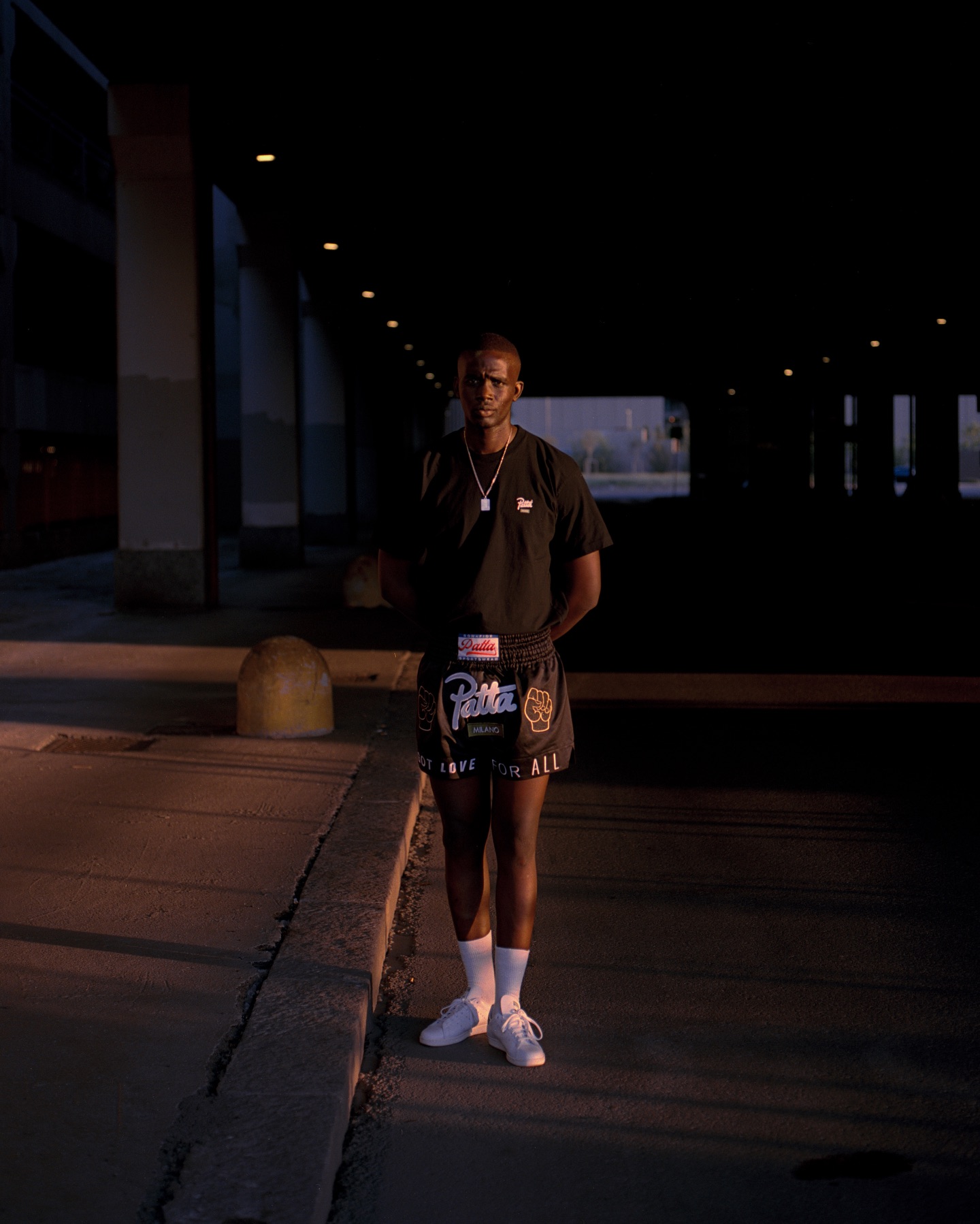 Models wearing Patta's Milan Chapter Series capsule, including the city specific tee and Chapter Muay Thai Shorts.