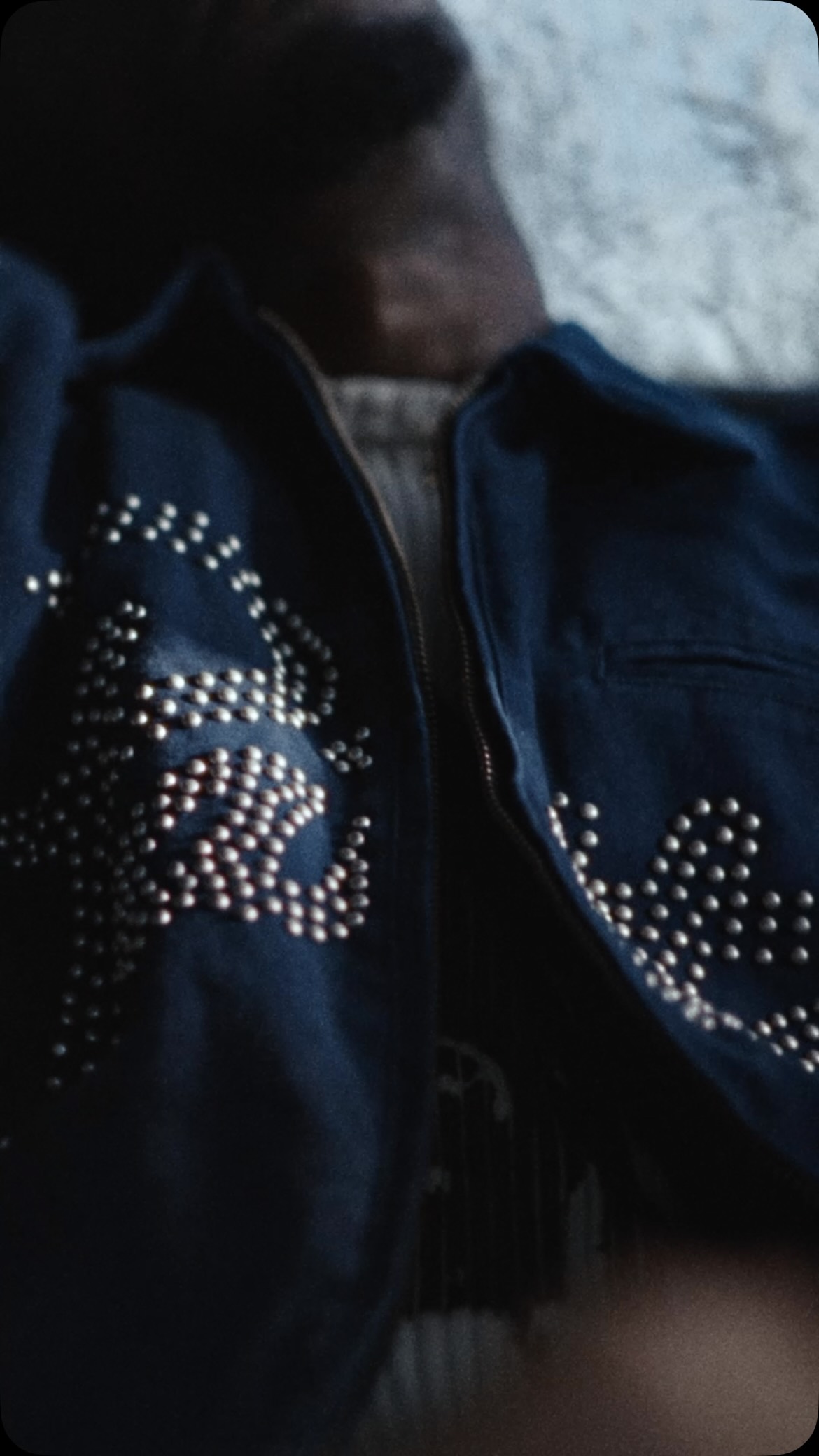 Bright decorative script runs across dark denim in Patta’s AW26 image.