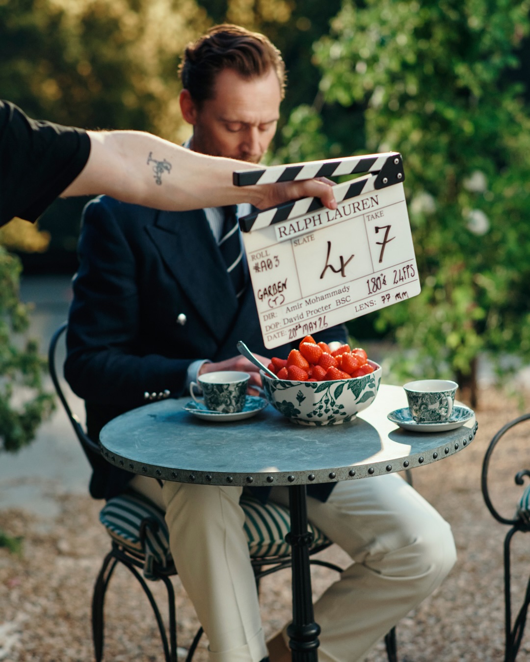 Ralph Lauren's Polo Bear mascot alongside actor Tom Hiddleston in a still from the brand's 2026 Wimbledon campaign film.