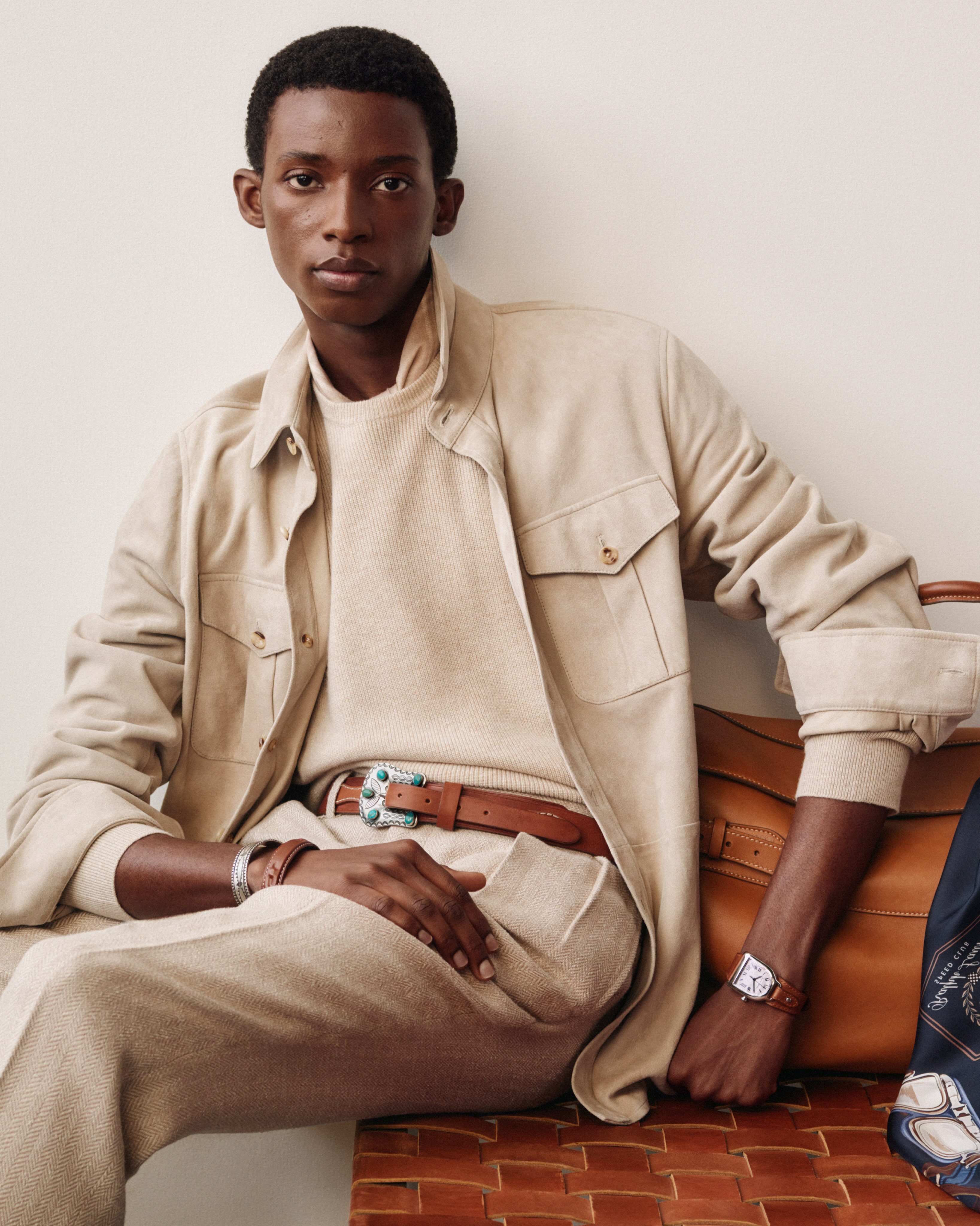 A Ralph Lauren Purple Label suede overshirt with a frosted wash finish, styled with a leather weekender bag and silver jewelry from Neil Zarama.