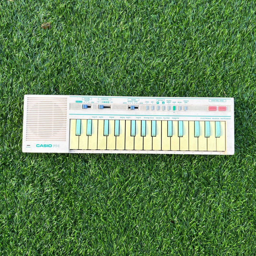 A vintage Casio PT-1 mini synthesizer keyboard photographed for a Reverb marketplace listing.