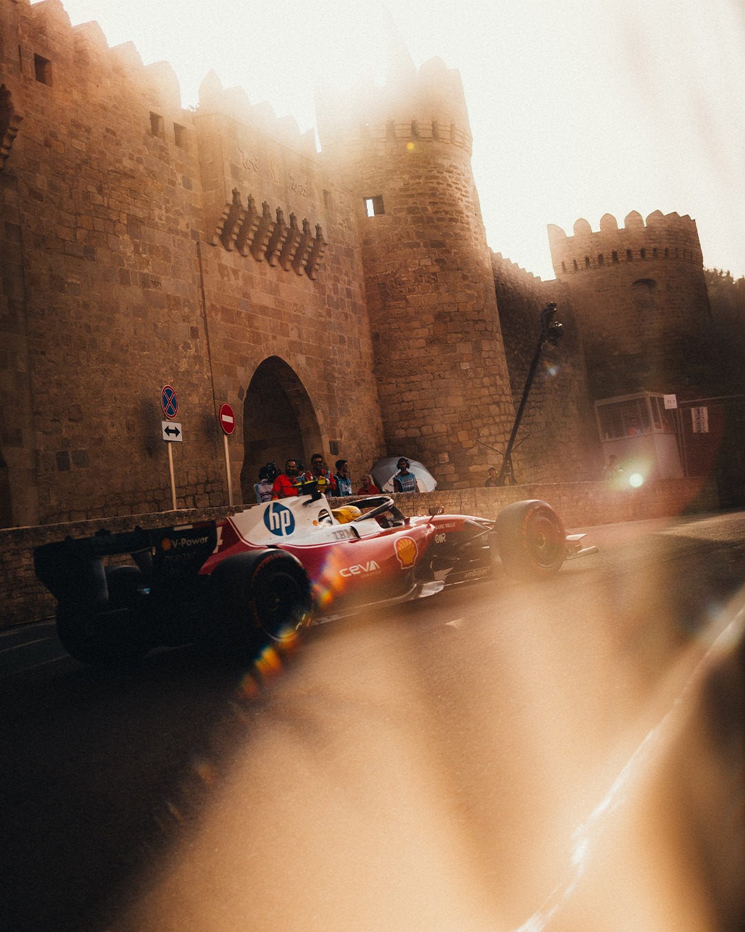A Ferrari Formula 1 car beside the stone walls of Baku old city.