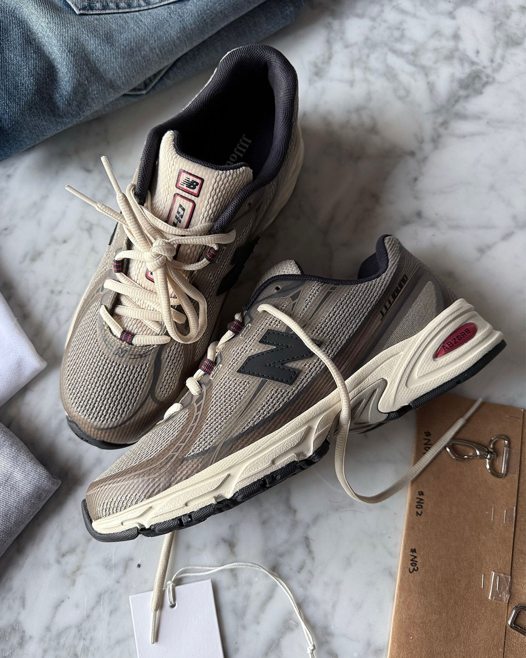 New Balance 740N sneaker in Jjjjound's brown and black Mushroom colorway with red tongue accents