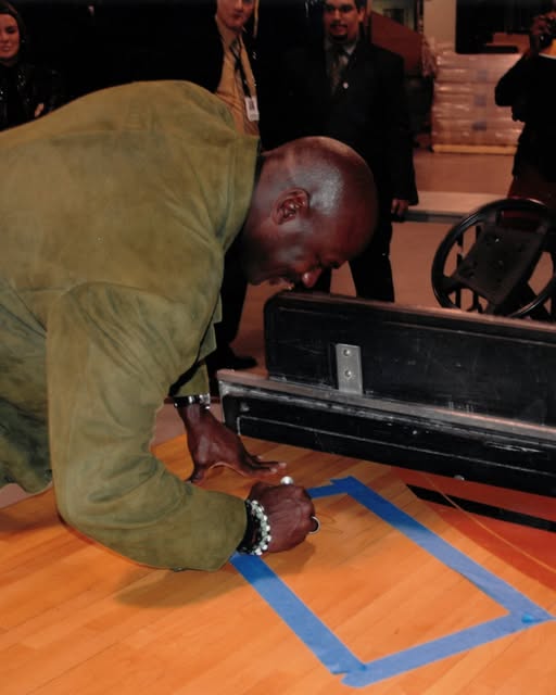 Chicago Bulls center court hardwood floor sections featuring the Bulls logo, signed by Michael Jordan and Scottie Pippen, before the Sotheby's July 2026 auction.