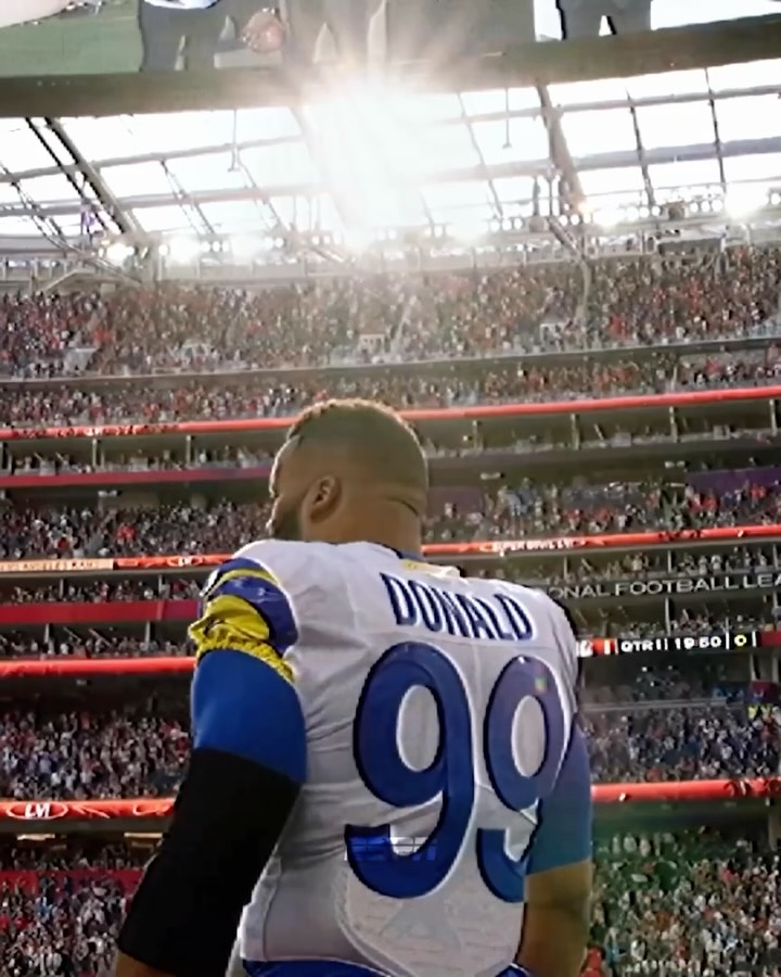 Aaron Donald in a white Rams number 99 jersey in archival footage used to promote his return.