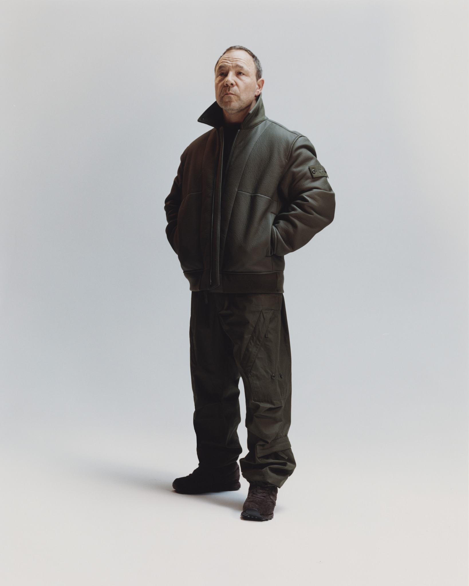 Stephen Graham photographed behind the scenes in Stone Island's 0100004 Ghost leather coach jacket.
