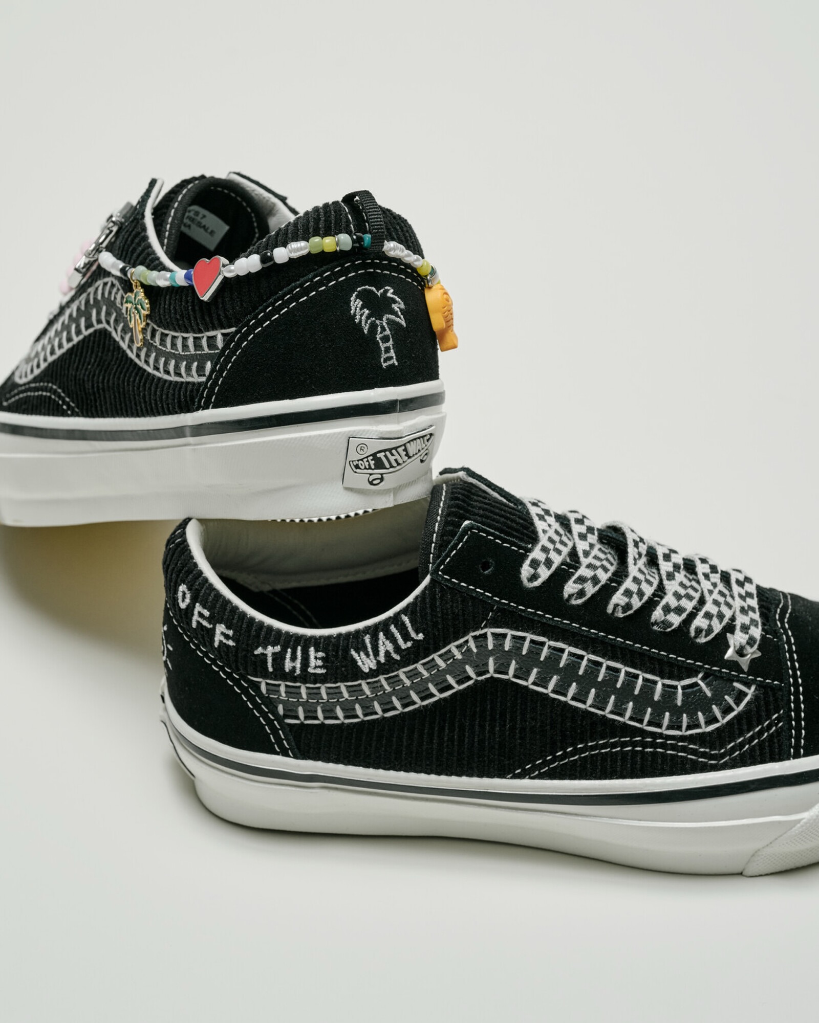 The Vans Premium Old Skool Cocona Hiraki in cream white, showing its corduroy and suede upper, removable friendship bracelet, and translucent outsole with hand drawn artwork.
