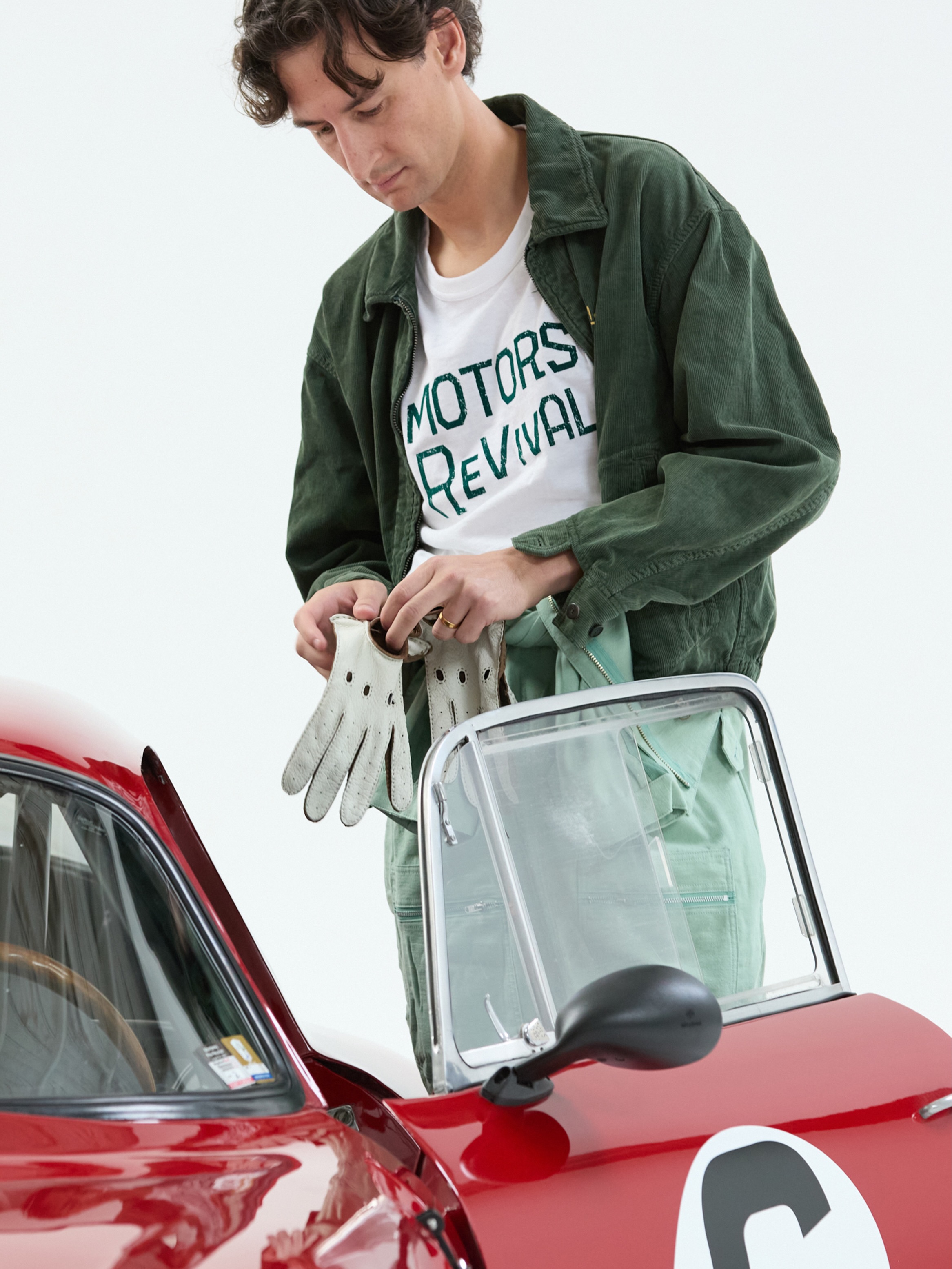 A model wearing Visvim Motors Club driving gear from the Mr Porter capsule