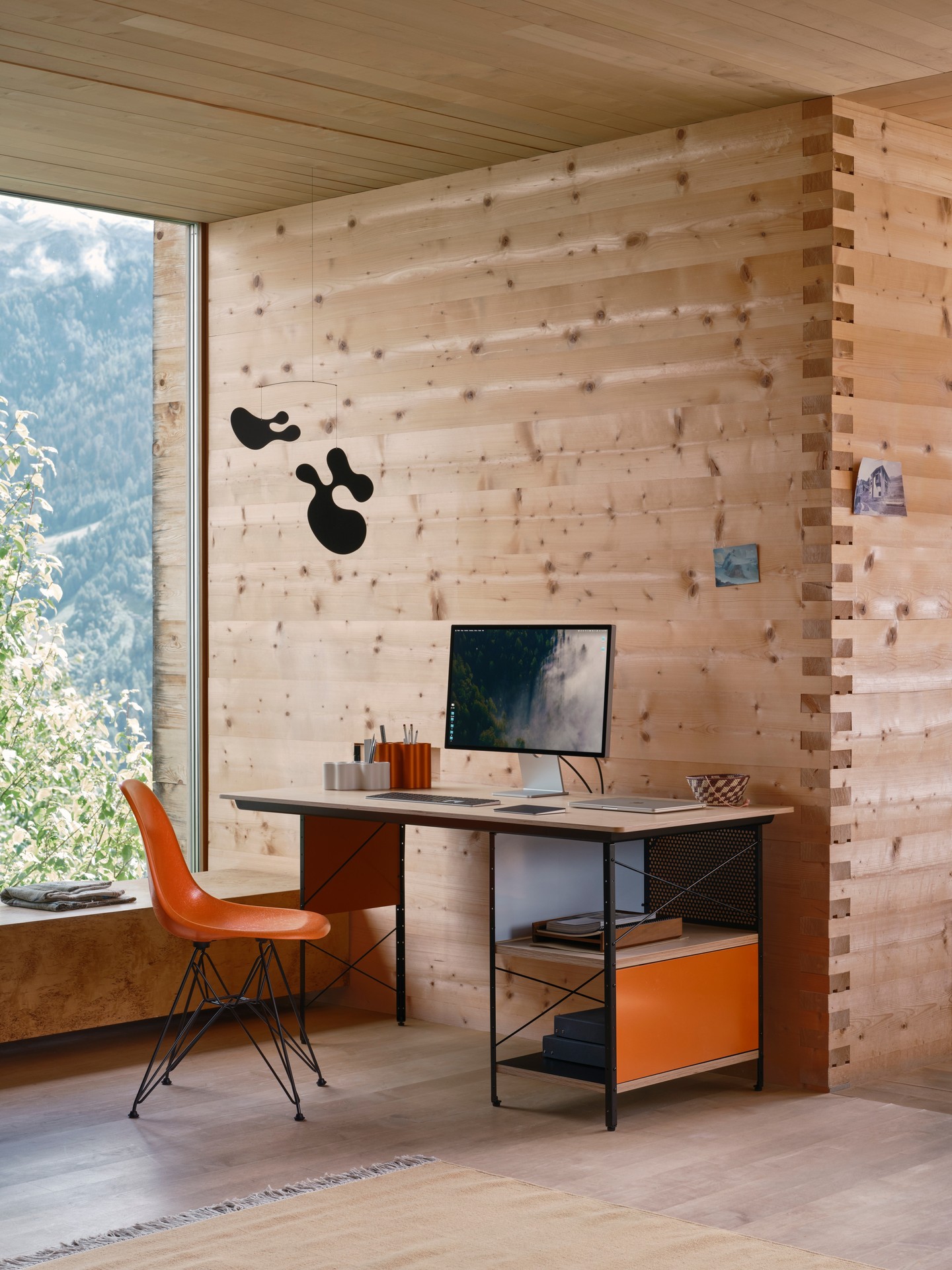 Vitra Eames Desk Unit with colored storage panels paired with an Eames Fiberglass Side Chair