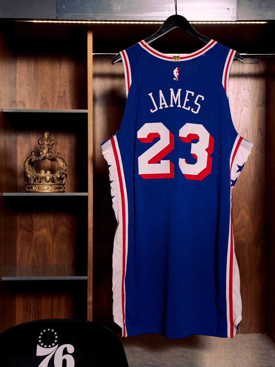 LeBron James' blue Philadelphia 76ers number 23 jersey hanging in a locker beside a crown