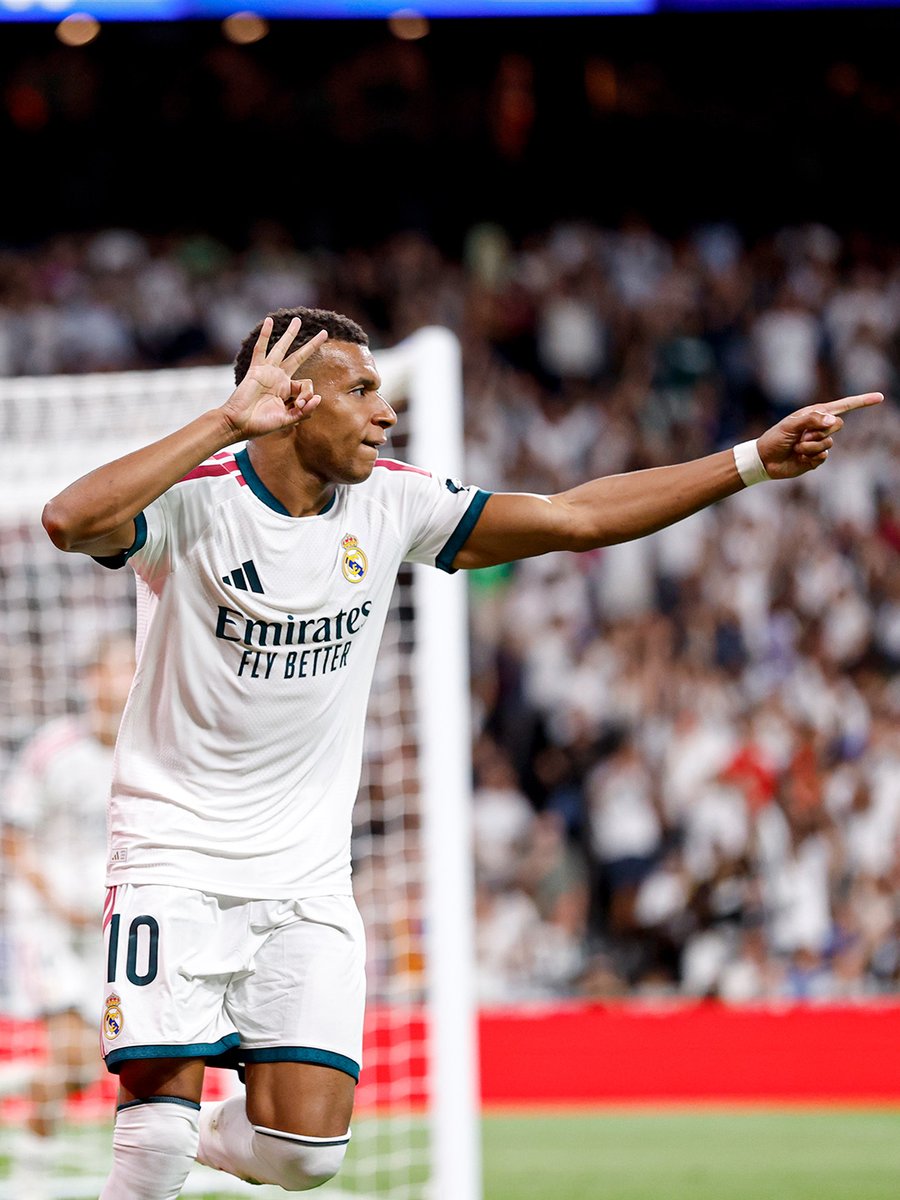 Kylian Mbappe celebrates his hat trick for Real Madrid against Real Sociedad at the Santiago Bernabeu, holding up three fingers