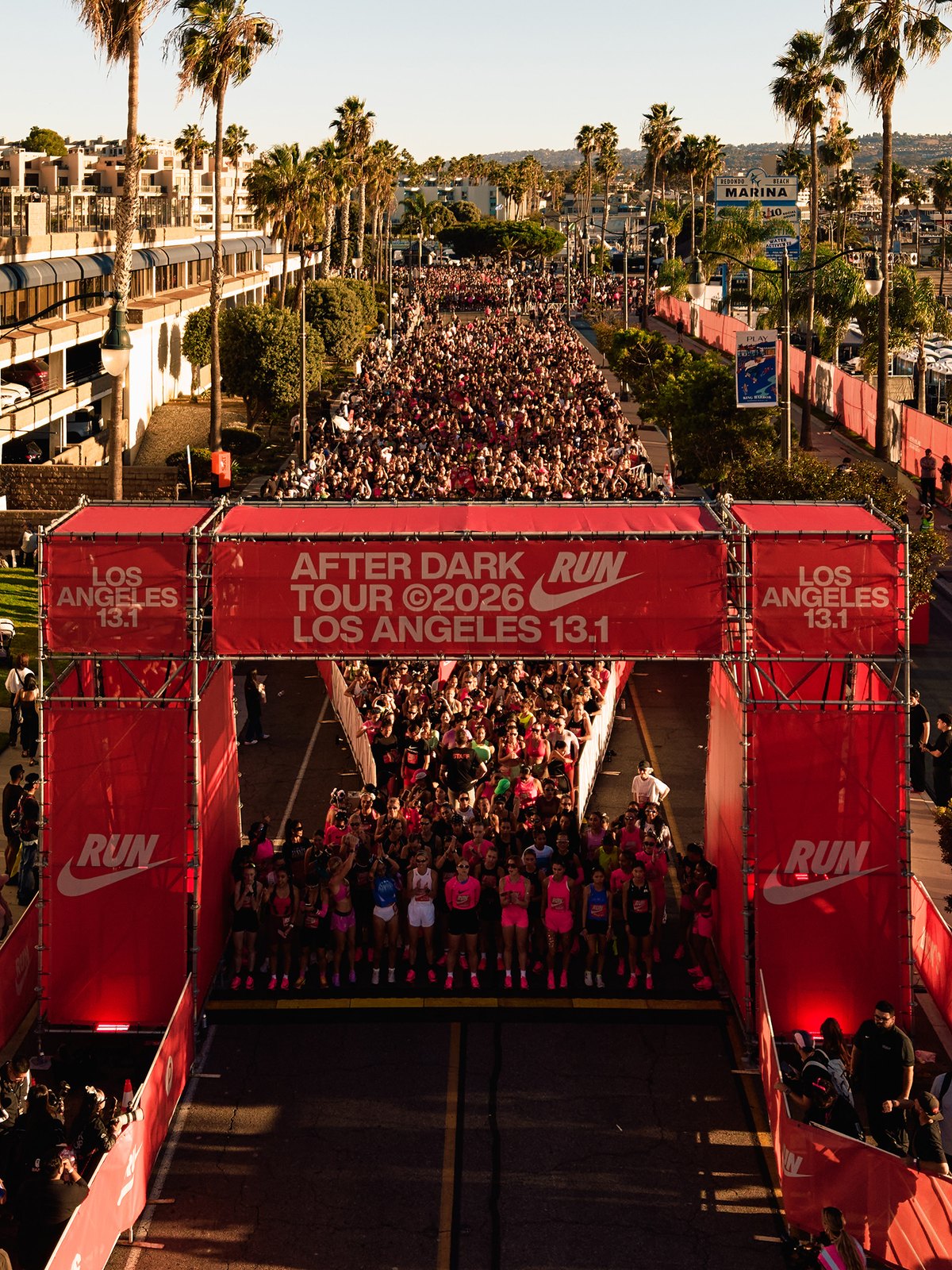 Thousands of women at the start arch of the Nike After Dark Tour Los Angeles 13.1 at Redondo Beach King Harbor