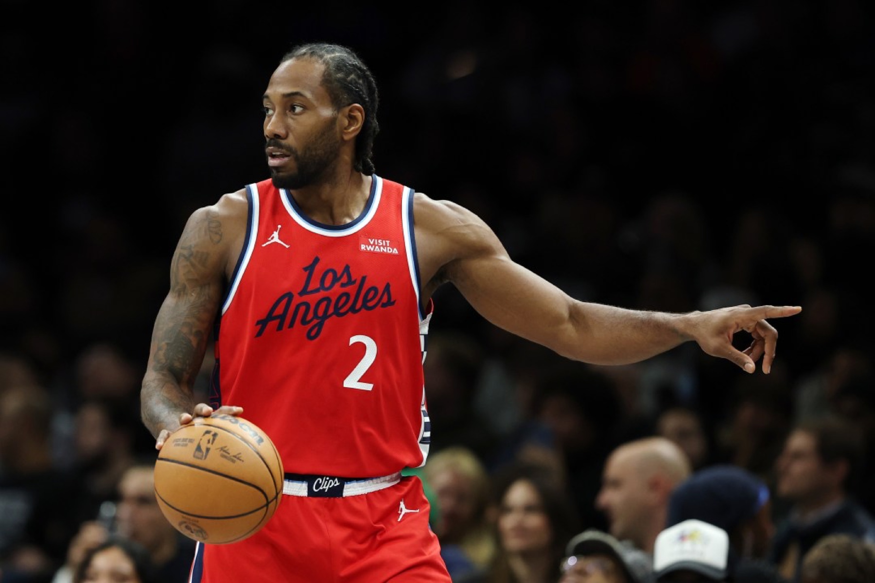 Kawhi Leonard in a red Los Angeles Clippers number 2 jersey directing play on the court